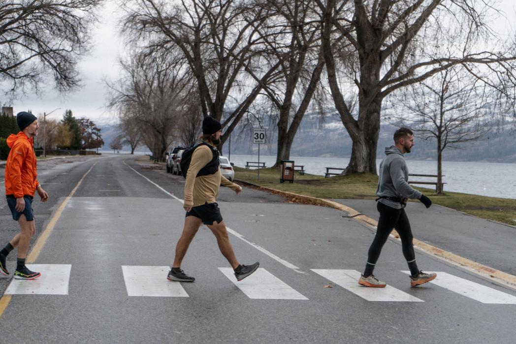 Sweat Culture run club members crossing Beach Ave in Peachland, BC, Abbey Road style, before finishing with a wood-fired sauna session