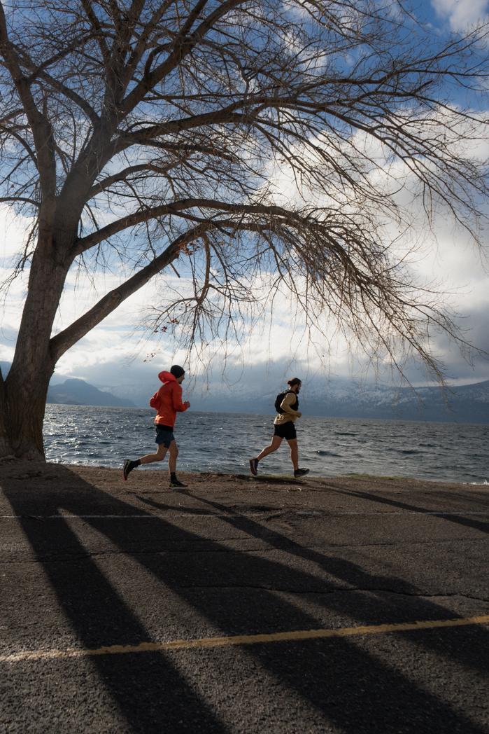Sweat Culture run club members on the Peachland waterfront in December, trail running followed by a wood-fired sauna session on Okanagan Lake
